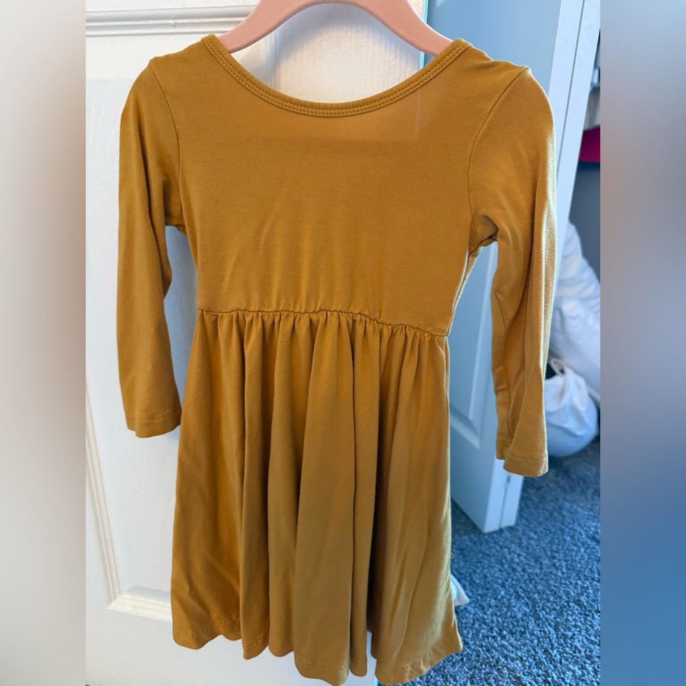 Kyte Baby Long Sleeve Dress in marigold 
Worn just a few times
